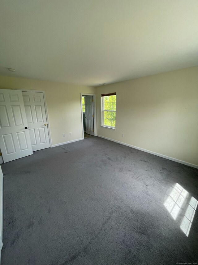 986 E St S, Suffield, CT 06078 - unfurnished room with baseboards and dark carpet