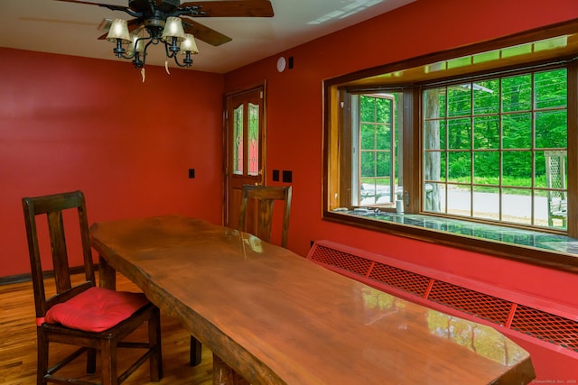 138 Baltic Hanover Rd, Sprague, CT 06330 - dining area featuring wood finished floors, a ceiling fan, and radiator heating unit