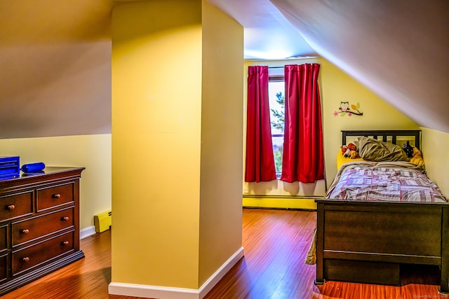 138 Baltic Hanover Rd, Sprague, CT 06330 - bedroom with a baseboard radiator, vaulted ceiling, dark wood finished floors, a baseboard heating unit, and baseboards