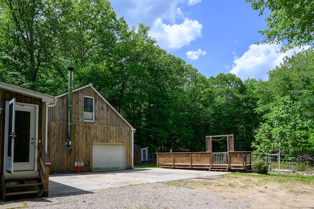 138 Baltic Hanover Rd, Sprague, CT 06330 - view of home's exterior featuring concrete driveway, a wooden deck, an outbuilding, and a garage