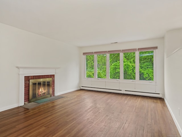 37 Windsor Ln, Greenwich, CT 06807 - unfurnished living room featuring a baseboard radiator, wood finished floors, baseboards, and a brick fireplace