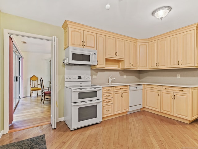 37 Windsor Ln, Greenwich, CT 06807 - kitchen with white appliances, light wood-type flooring, light brown cabinetry, a sink, and light countertops