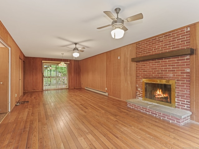 37 Windsor Ln, Greenwich, CT 06807 - unfurnished living room with baseboard heating, hardwood / wood-style floors, ceiling fan, a brick fireplace, and wooden walls