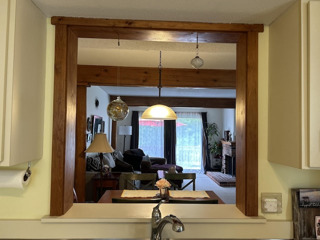6 Deer Hill Ct Unit 6, Woodbury, CT 06798 - living area with beam ceiling, a brick fireplace, and carpet