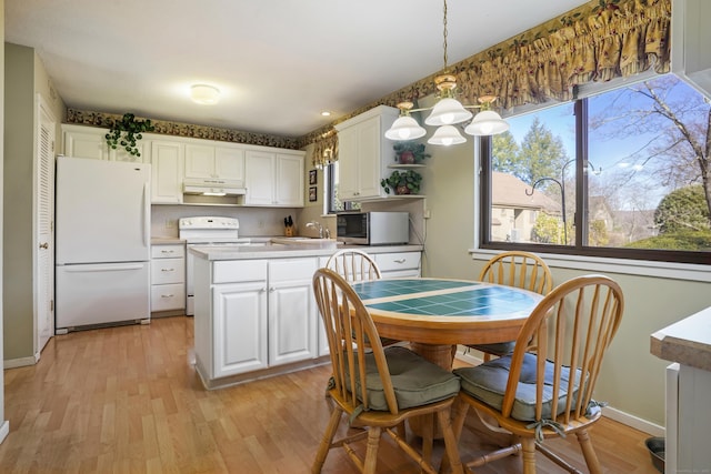 78 Heritage Vlg Unit A, Southbury, CT 06488 - dining space featuring light wood-style flooring and baseboards