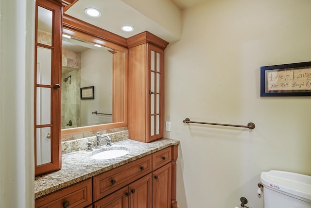 78 Heritage Vlg Unit A, Southbury, CT 06488 - bathroom with toilet, a tile shower, vanity, and recessed lighting