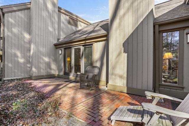 78 Heritage Vlg Unit A, Southbury, CT 06488 - rear view of house with a shingled roof, a chimney, and a patio area
