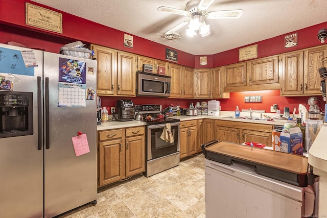 108 Ashmead Commons Unit 108, Enfield, CT 06082 - kitchen featuring stainless steel appliances, ceiling fan, brown cabinetry, light countertops, and a sink