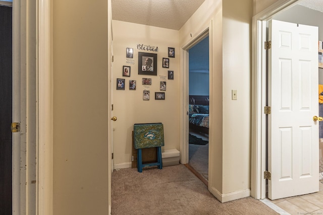108 Ashmead Commons Unit 108, Enfield, CT 06082 - corridor with light carpet, baseboards, and a textured ceiling