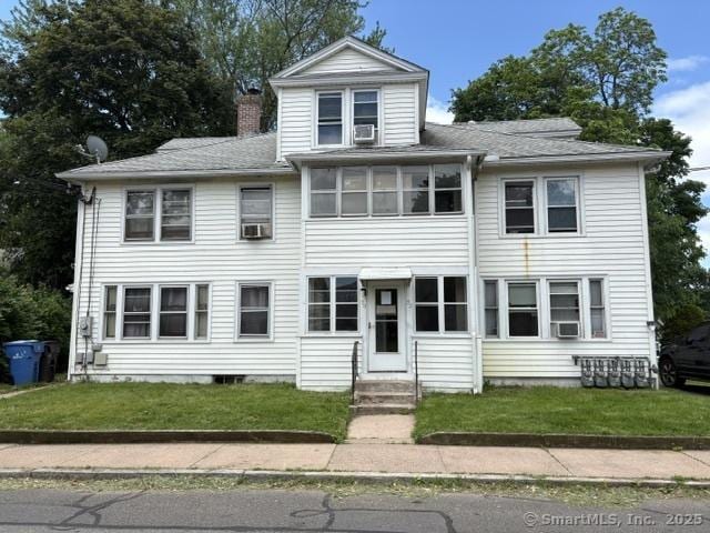 50 N St, Manchester, CT 06042 - view of front facade featuring a chimney, entry steps, a front lawn, and a shingled roof