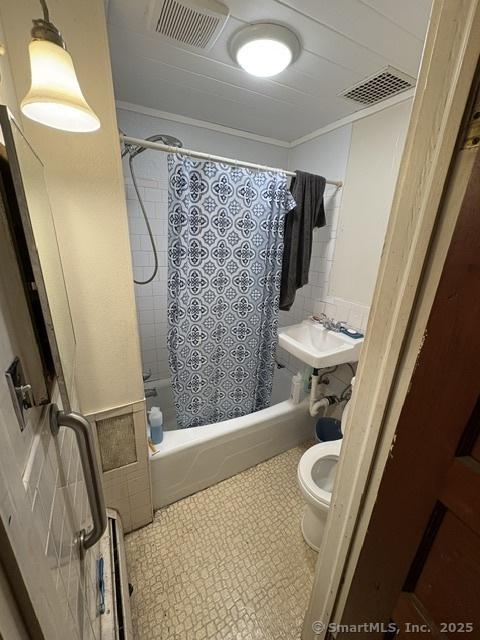 50 N St, Manchester, CT 06042 - bathroom featuring toilet, shower / bath combo, a sink, and tile walls