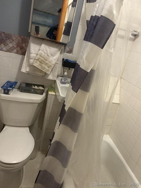 50 N St, Manchester, CT 06042 - bathroom with tile walls, toilet, and shower / bath combo