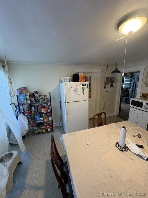 50 N St, Manchester, CT 06042 - kitchen with white appliances, tile patterned floors, white cabinets, and light countertops