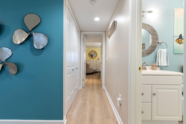 1 Mansfield Grove Rd Apt 205, East Haven, CT 06512 - corridor featuring a sink, light wood-type flooring, recessed lighting, and baseboards