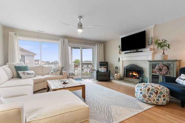 1 Mansfield Grove Rd Apt 205, East Haven, CT 06512 - living area with wood finished floors, a lit fireplace, and a ceiling fan