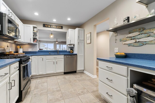 1 Mansfield Grove Rd Apt 205, East Haven, CT 06512 - kitchen with appliances with stainless steel finishes, open shelves, dark countertops, white cabinetry, and recessed lighting
