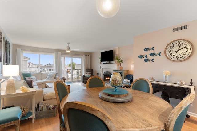 1 Mansfield Grove Rd Apt 205, East Haven, CT 06512 - dining area with a warm lit fireplace, wood finished floors, and a ceiling fan