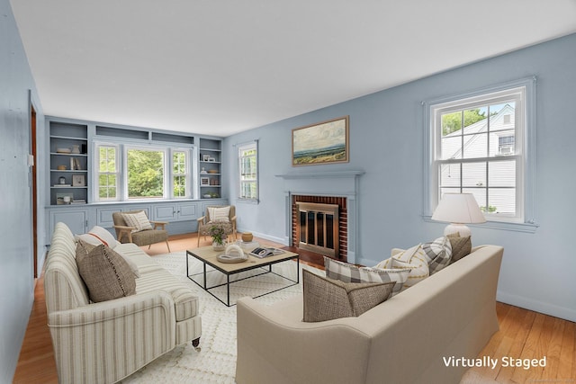 10 Richmond Rd, West Hartford, CT 06117 - living room with wood finished floors, built in features, a brick fireplace, and baseboards