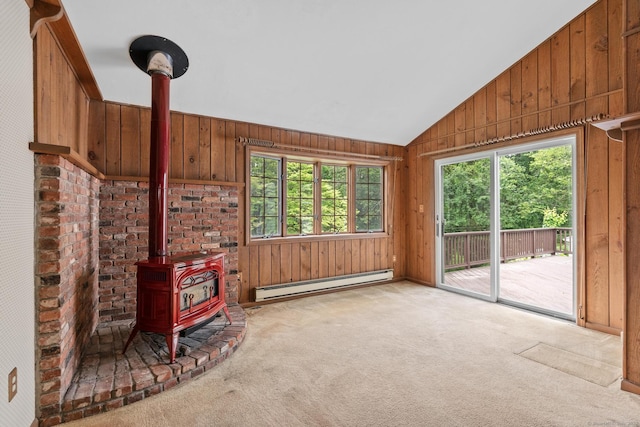 10 Richmond Rd, West Hartford, CT 06117 - unfurnished living room with a baseboard radiator, a wood stove, carpet, wooden walls, and vaulted ceiling