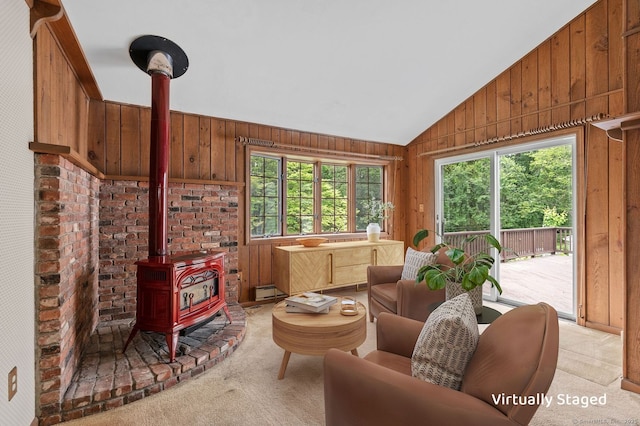 10 Richmond Rd, West Hartford, CT 06117 - living room with a wood stove, wooden walls, light colored carpet, and lofted ceiling