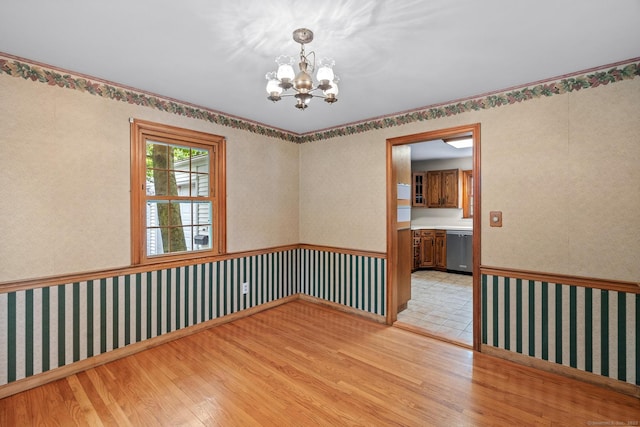 10 Richmond Rd, West Hartford, CT 06117 - unfurnished room featuring light wood-type flooring, a chandelier, a wainscoted wall, and wallpapered walls