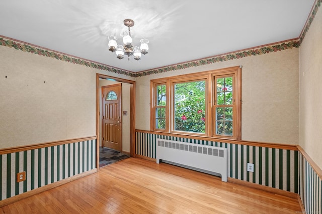 10 Richmond Rd, West Hartford, CT 06117 - unfurnished room with radiator, wood-type flooring, wallpapered walls, and a chandelier