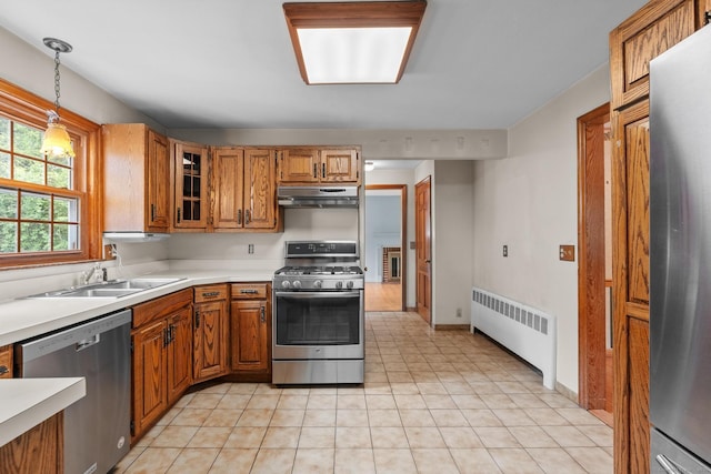 10 Richmond Rd, West Hartford, CT 06117 - kitchen featuring radiator heating unit, stainless steel appliances, under cabinet range hood, and brown cabinets