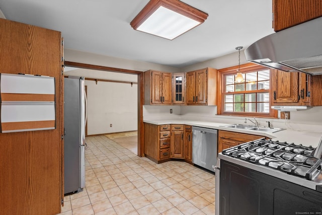 10 Richmond Rd, West Hartford, CT 06117 - kitchen featuring stainless steel appliances, exhaust hood, brown cabinets, light countertops, and decorative light fixtures