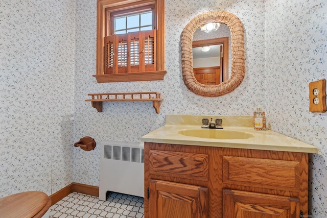 10 Richmond Rd, West Hartford, CT 06117 - bathroom featuring radiator heating unit, wallpapered walls, vanity, toilet, and baseboards