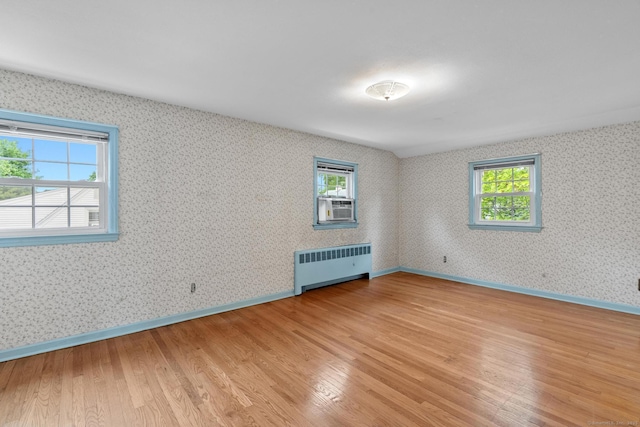 10 Richmond Rd, West Hartford, CT 06117 - empty room with radiator, light wood-type flooring, plenty of natural light, and wallpapered walls