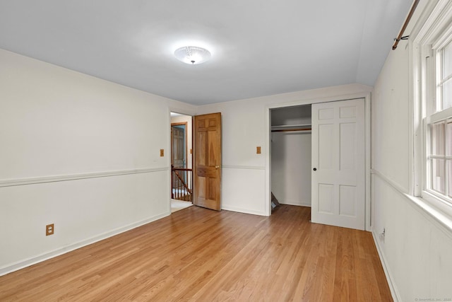10 Richmond Rd, West Hartford, CT 06117 - unfurnished bedroom with light wood-type flooring, a closet, multiple windows, and baseboards