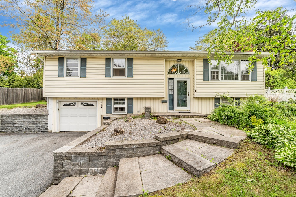 211 Fairlawn Dr, Torrington, CT 06790 - split foyer home featuring an attached garage and driveway