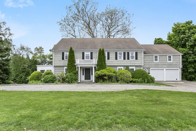 440 Hilltop Rd, Bridgeport, CT 06605 - colonial inspired home featuring a front lawn, a balcony, an attached garage, and driveway