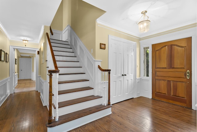 440 Hilltop Rd, Bridgeport, CT 06605 - foyer entrance featuring a decorative wall, stairway, dark wood-type flooring, crown molding, and wainscoting