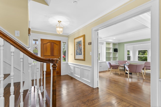 440 Hilltop Rd, Bridgeport, CT 06605 - entrance foyer featuring dark wood finished floors, stairs, ornamental molding, a wainscoted wall, and a decorative wall
