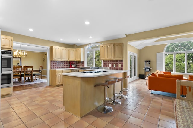 440 Hilltop Rd, Bridgeport, CT 06605 - kitchen featuring stainless steel double oven, light brown cabinetry, light countertops, healthy amount of natural light, and recessed lighting