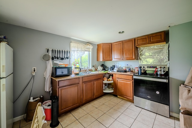 88 Boston Post Rd, Milford, CT 06460 - kitchen with stainless steel electric range, white refrigerator with ice dispenser, a sink, black microwave, and light tile patterned floors