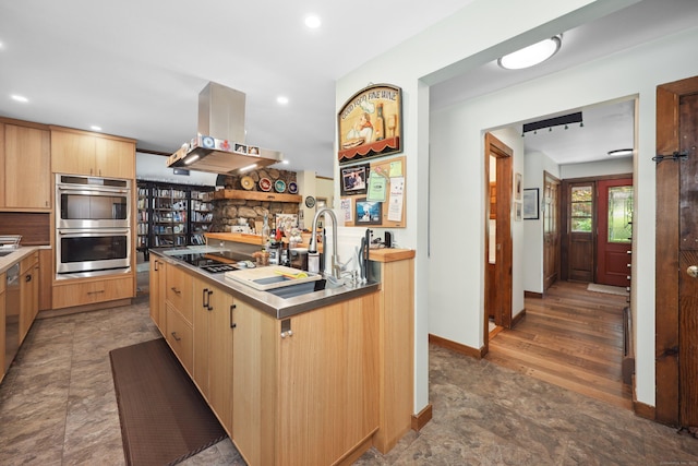 11 College Hill Rd, North Canaan, CT 06018 - kitchen featuring island exhaust hood, stainless steel double oven, light brown cabinets, electric cooktop, and stainless steel counters