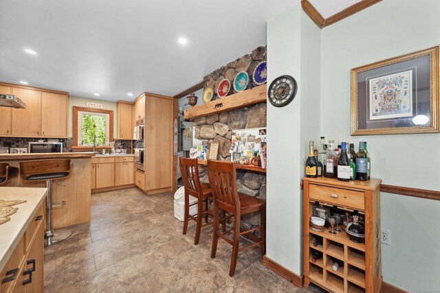 11 College Hill Rd, North Canaan, CT 06018 - kitchen with light brown cabinets, a kitchen bar, stainless steel appliances, recessed lighting, and light countertops