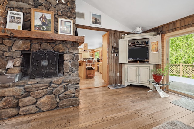 11 College Hill Rd, North Canaan, CT 06018 - living room with wood-type flooring, vaulted ceiling, healthy amount of natural light, a fireplace, and wood walls