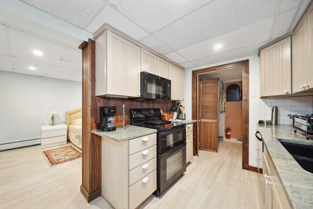 11 College Hill Rd, North Canaan, CT 06018 - kitchen with black appliances, a paneled ceiling, a baseboard heating unit, light wood finished floors, and tasteful backsplash
