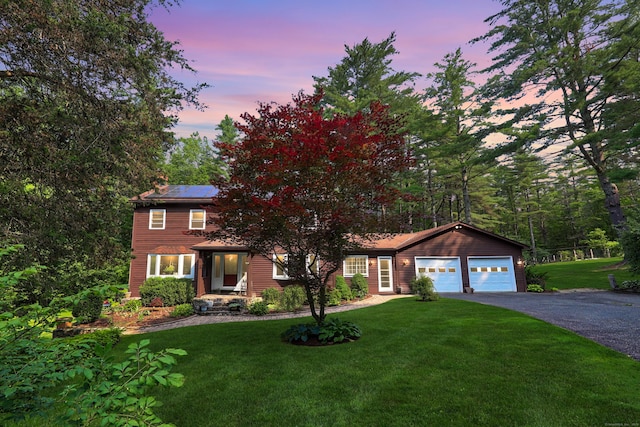 11 College Hill Rd, North Canaan, CT 06018 - view of front of property with asphalt driveway, a lawn, roof mounted solar panels, and a garage