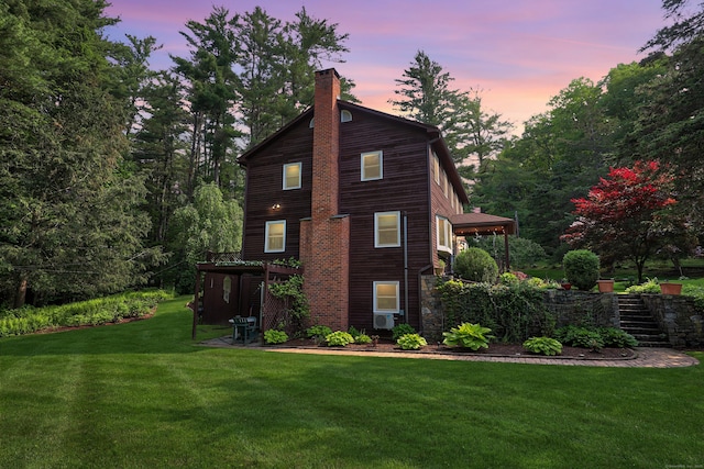 11 College Hill Rd, North Canaan, CT 06018 - property exterior at dusk with stairs, a chimney, and a yard