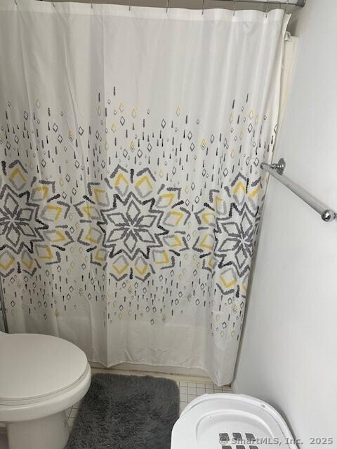 243 Lawlor St Apt 2C, New Britain, CT 06051 - bathroom featuring toilet, tile patterned floors, and a shower with curtain