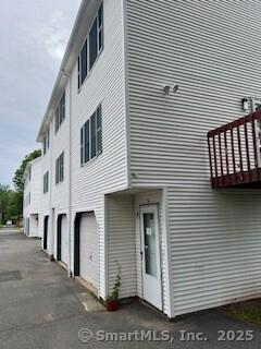 243 Lawlor St Apt 2C, New Britain, CT 06051 - view of building exterior with a garage