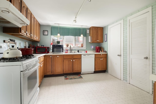 7 Lawrence Ave, North Canaan, CT 06018 - kitchen with white appliances, under cabinet range hood, brown cabinets, light countertops, and light flooring