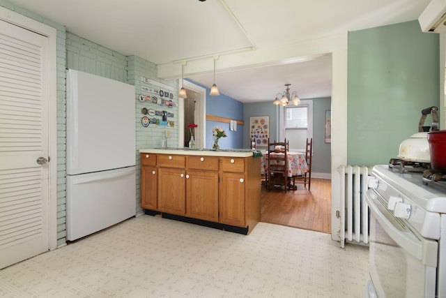 7 Lawrence Ave, North Canaan, CT 06018 - kitchen featuring white appliances, brown cabinetry, a peninsula, radiator heating unit, and a chandelier