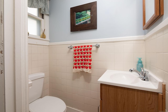7 Lawrence Ave, North Canaan, CT 06018 - bathroom with tile walls, vanity, toilet, and wainscoting