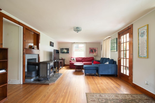 7 Lawrence Ave, North Canaan, CT 06018 - living area with light wood-style floors, baseboards, and a wood stove