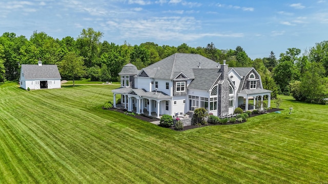 562 Upper Grassy Hill Rd, Woodbury, CT 06798 - back of property with a porch, a lawn, a chimney, an outbuilding, and a shingled roof